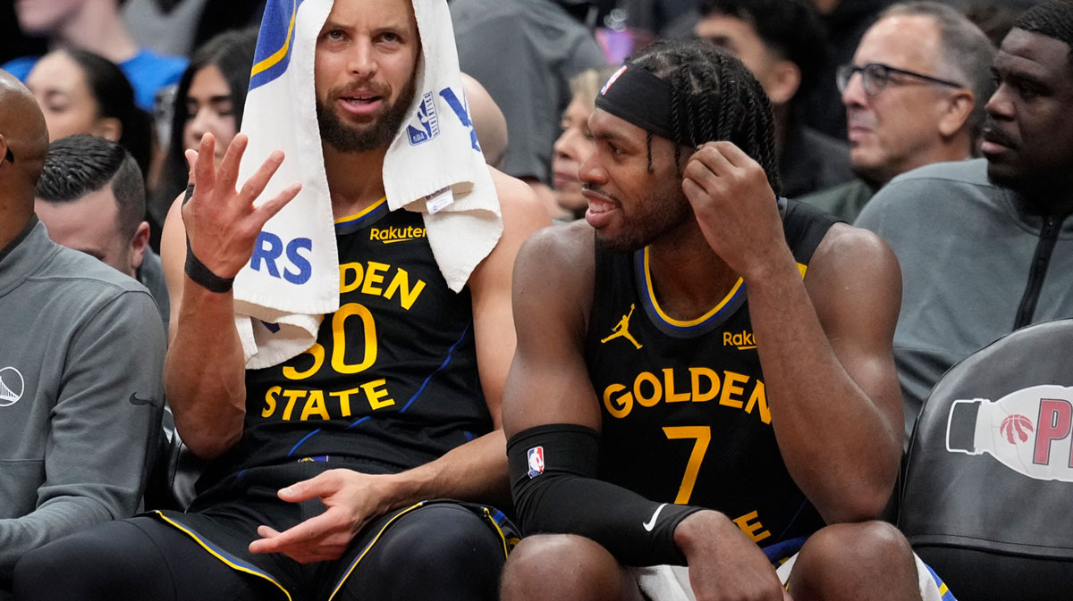 Golden State Warriors guard Stephen Curry (30) and guard Buddy Hield (7) talk on the bench during the second half against the Toronto Raptors at Scotiabank Arena. 
