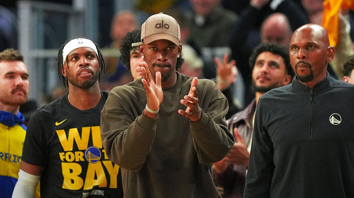 Golden State Warriors forward Jimmy Butler III (center) applauds from the bench against the Houston Rockets during the third quarter of game three of first round for the 2024 NBA Playoffs at Chase Center