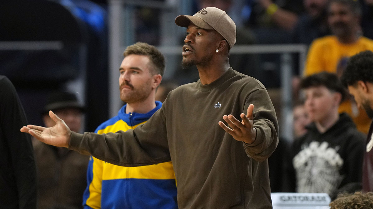 Golden State Warriors forward Jimmy Butler III (center) yells from the bench against the Houston Rockets during the third quarter of game three of first round for the 2024 NBA Playoffs at Chase Center