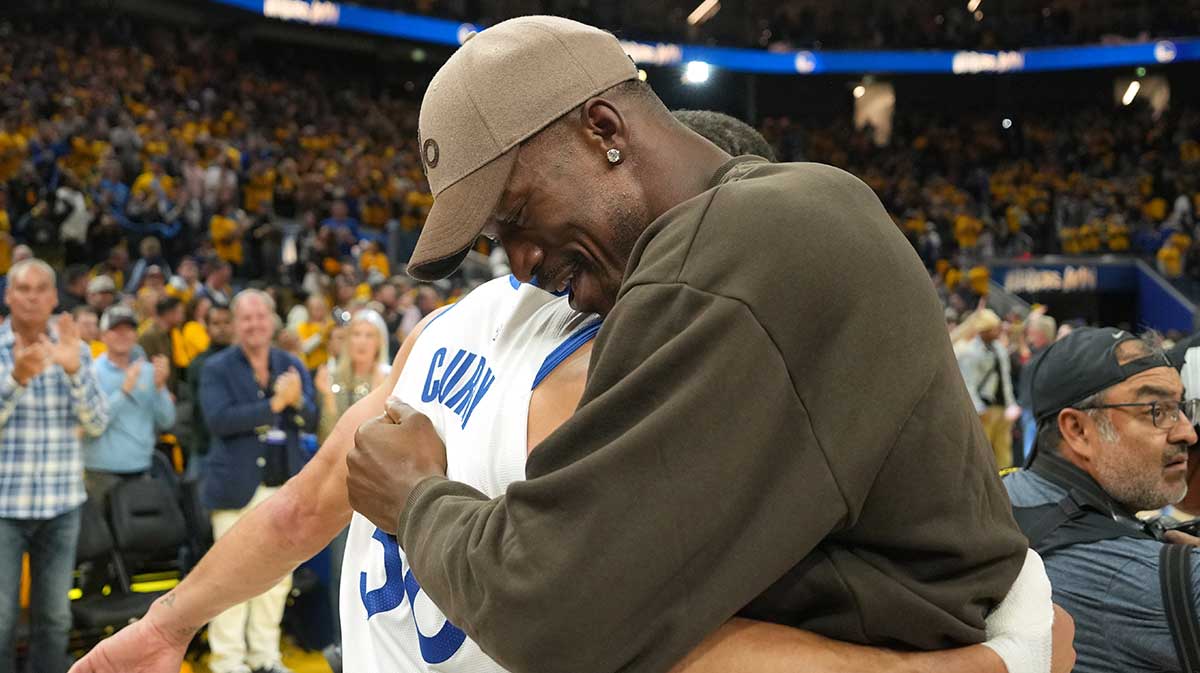 Golden State Warriors guard Stephen Curry (left) and forward Jimmy Butler III (right) hug after defeating the Houston Rockets during game three of first round for the 2024 NBA Playoffs at Chase Center.