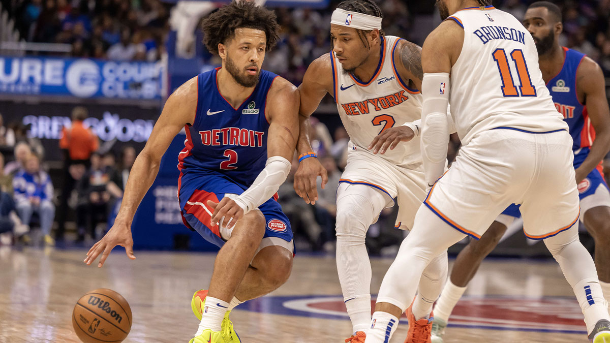 Detroit Pistons guard Cade Cunningham (2) controls the ball next to New York Knicks guard Miles McBride (2) during the second half at Little Caesars Arena.