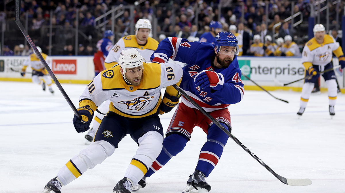 Nashville Predators center Ryan O'Reilly (90) and New York Rangers defenseman Calvin de Haan (44) fight for position during the first period at Madison Square Garden.
