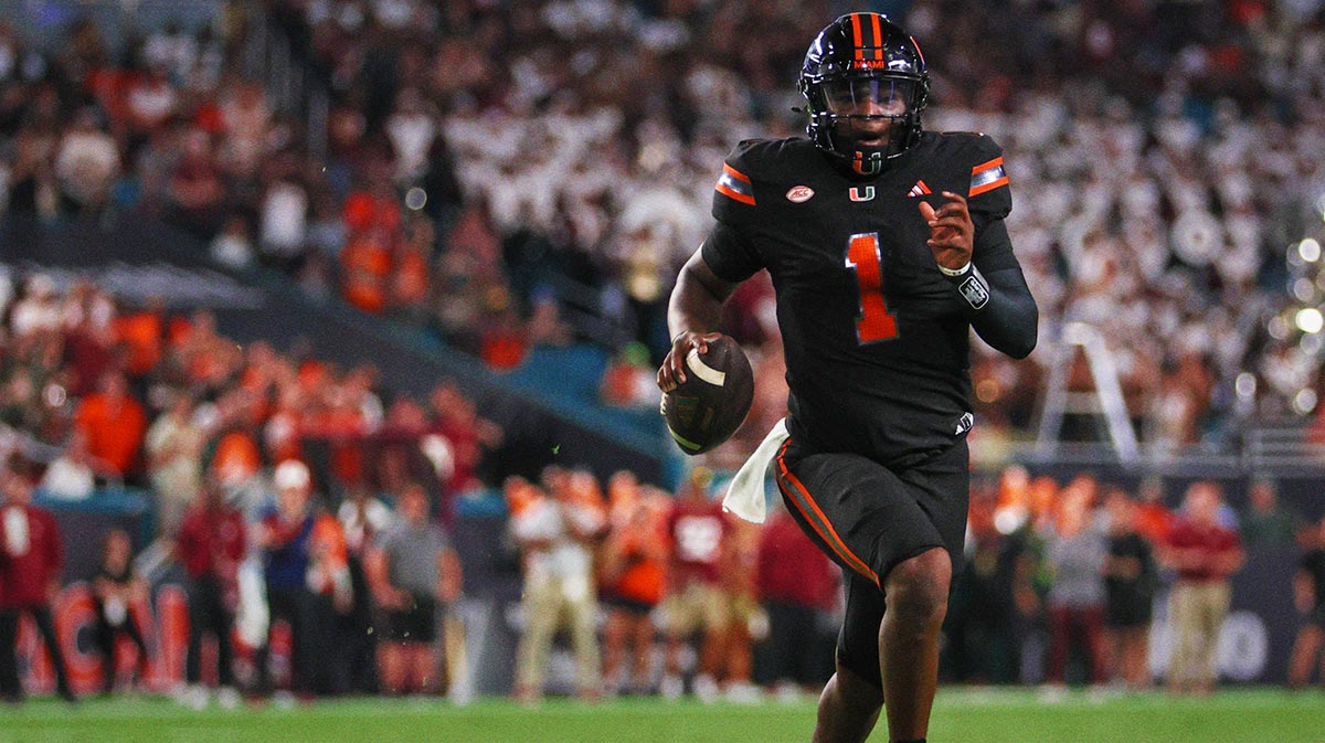 Miami Hurricanes quarterback Cam Ward (1) runs with the football against the Florida State Seminoles during the second quarter at Hard Rock Stadium.