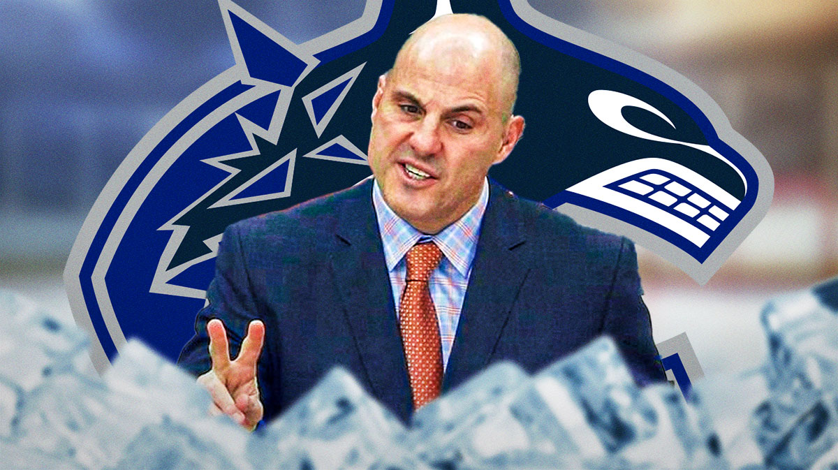 Rick Tocchet next to Canucks logo