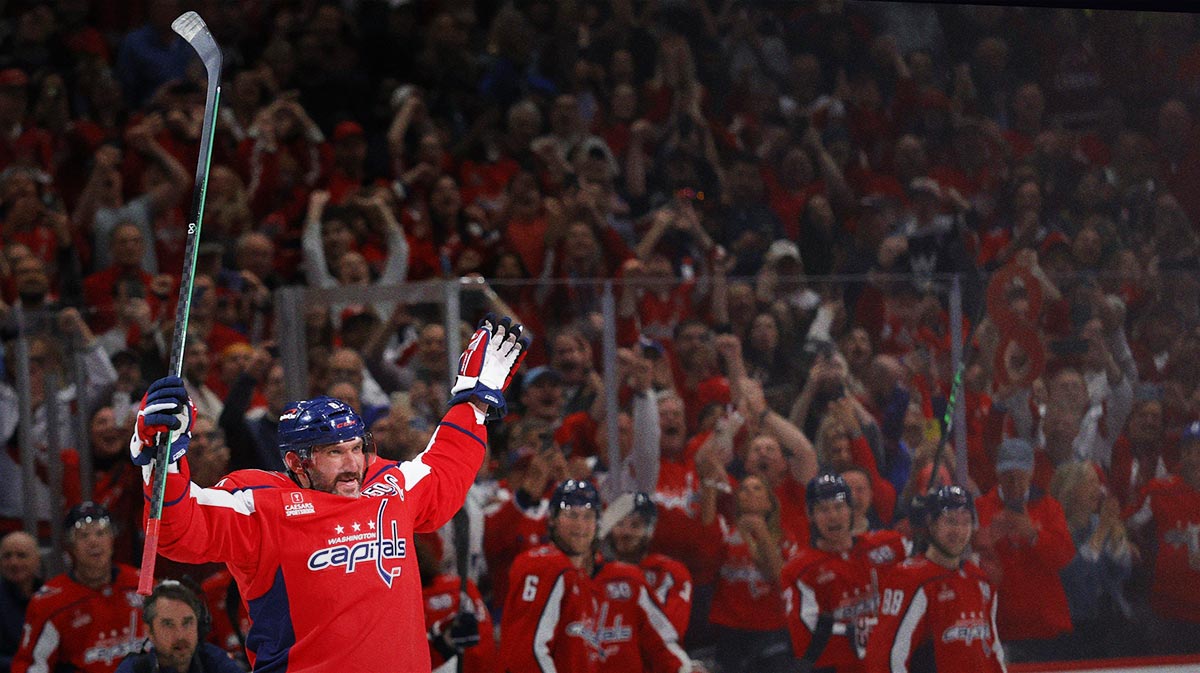 Washington Capitals left wing Alex Ovechkin (8) waves to the crowd from center ice after scoring his 894th career goal on a goal against the Chicago Blackhawks in the third period at Capital One Arena. Ovechkin tied Wayne Gretzky (not pictured) for the all time record for career goal with the goal