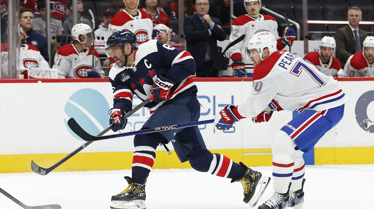 Washington Capitals left wing Alex Ovechkin (8) shoots the puck as Montreal Canadiens left wing Tanner Pearson (70) defends in the third period at Capital One Arena.