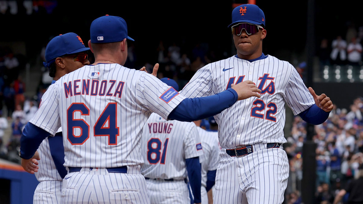 New York Mets manager Carlos Mendoza (64) greets right fielder Juan Soto (22) during introductions before the Mets home opener against the Toronto Blue Jays at Citi Field.