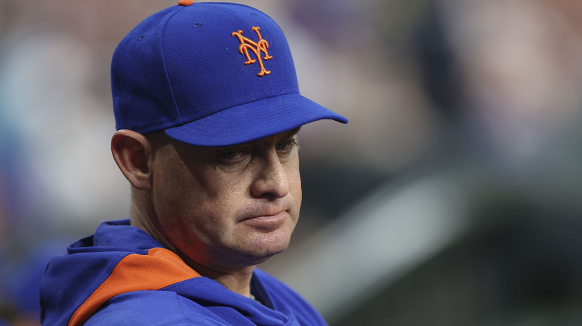 New York Mets manager Carlos Mendoza looks on from the dugout during the game against the Houston Astros at Daikin Park