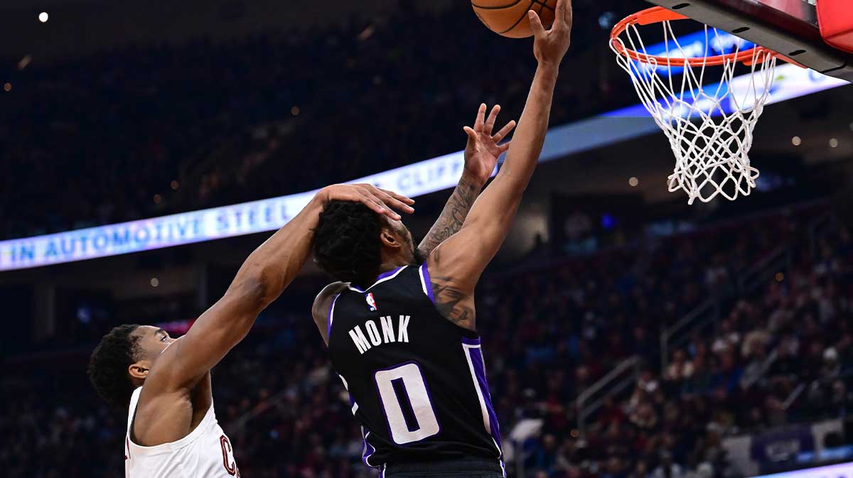 Cleveland Cavaliers guard Donovan Mitchell (45) fouls Sacramento Kings guard Malik Monk (0) during the first half at Rocket Arena.