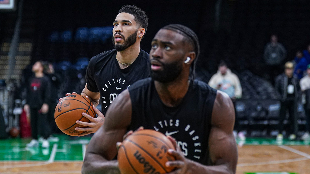 Boston Celtics forward Jayson Tatum (0) and guard Jaylen Brown (7) warm up before the start of the game against the Houston Rockets at TD Garden.