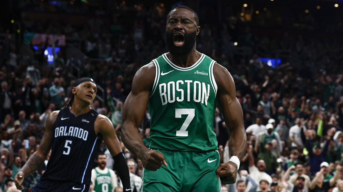 Celtics guard Jaylen Brown (7) shouts out after dunking as Orlando Magic forward Paolo Banchero (5) turns away during the second half of game two of the first round of the 2024 NBA Playoffs at TD Garden with Celtics' Jayson Tatum on the bench