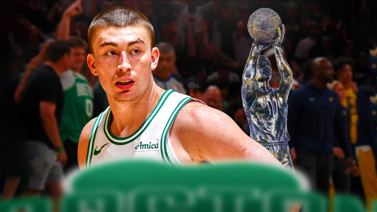 Payton Pritchard looking serious (or mid-shooting the ball) next to the 6th Man of the Year trophy