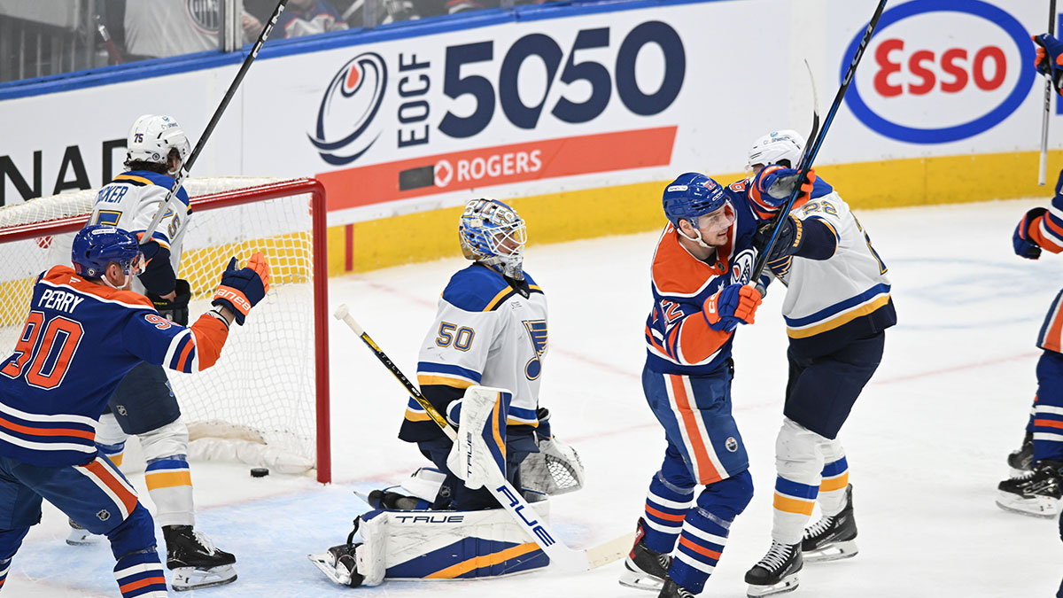Edmonton Oilers right wing Corey Perry (90) celebrates a goal against St. Louis Blues goalie Jordan Binnington (50) as Oilers right wing Vasily Podkolzin (92) and defenseman Ryan Suter (22) battle during the second period at Rogers Place.