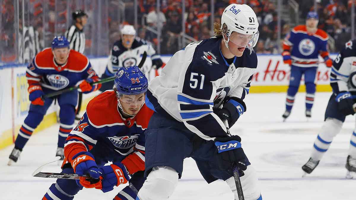 Winnipeg Jets forward Chaz Lucius (51) makes a pass in front Edmonton Oilers forward Xavier Bourgault (54) during the third period at Rogers Place.