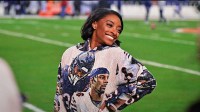 Dec 26, 2024; Chicago, Illinois, USA; United States gymnast Simone Biles poses for a photo on the sidelines before the game between the Chicago Bears and the Seattle Seahawks at Soldier Field. Mandatory Credit: Daniel Bartel-Imagn Images