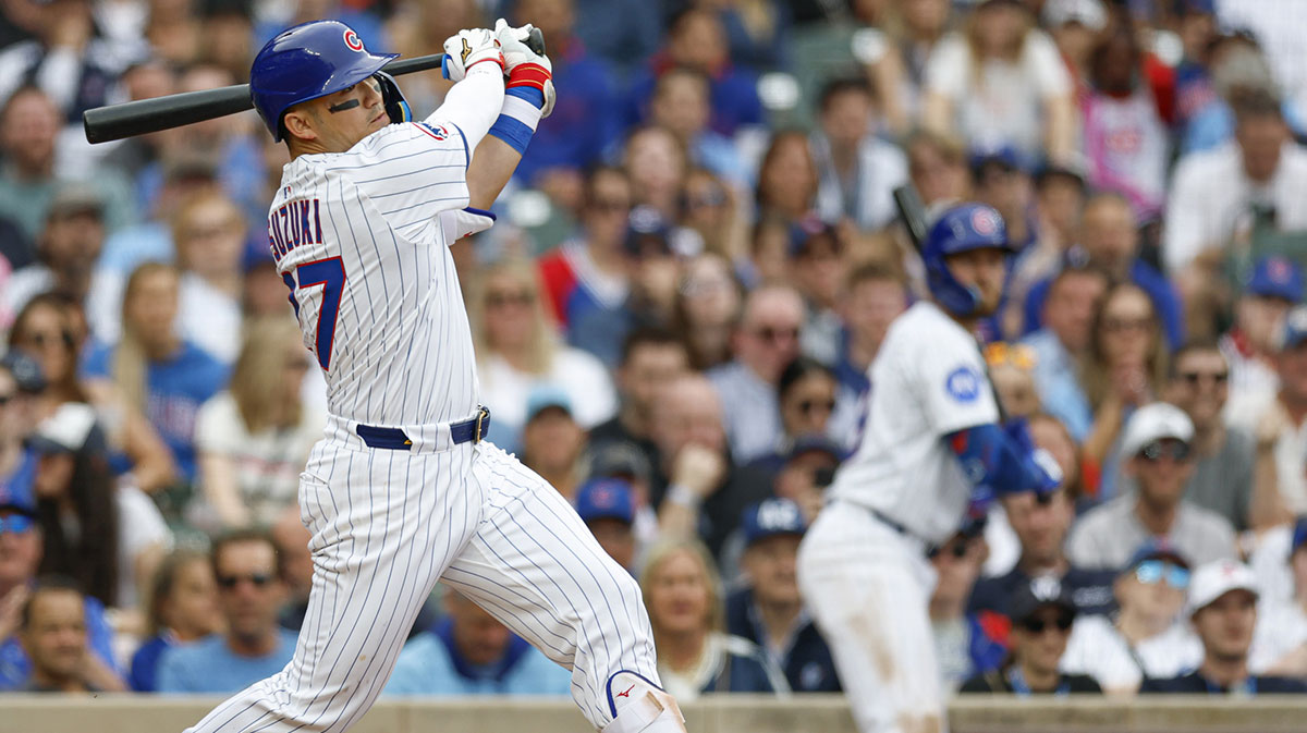 Chicago Cubs designated hitter Seiya Suzuki (27) hits a solo home run against the Arizona Diamondbacks during the eight inning at Wrigley Field.
