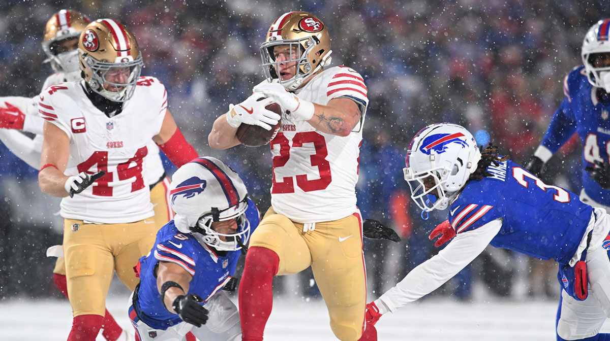 San Francisco 49ers running back Christian McCaffrey (23) is tackled by Buffalo Bills safety Taylor Rapp (9) and safety Damar Hamlin (3) in the second quarter at Highmark Stadium.