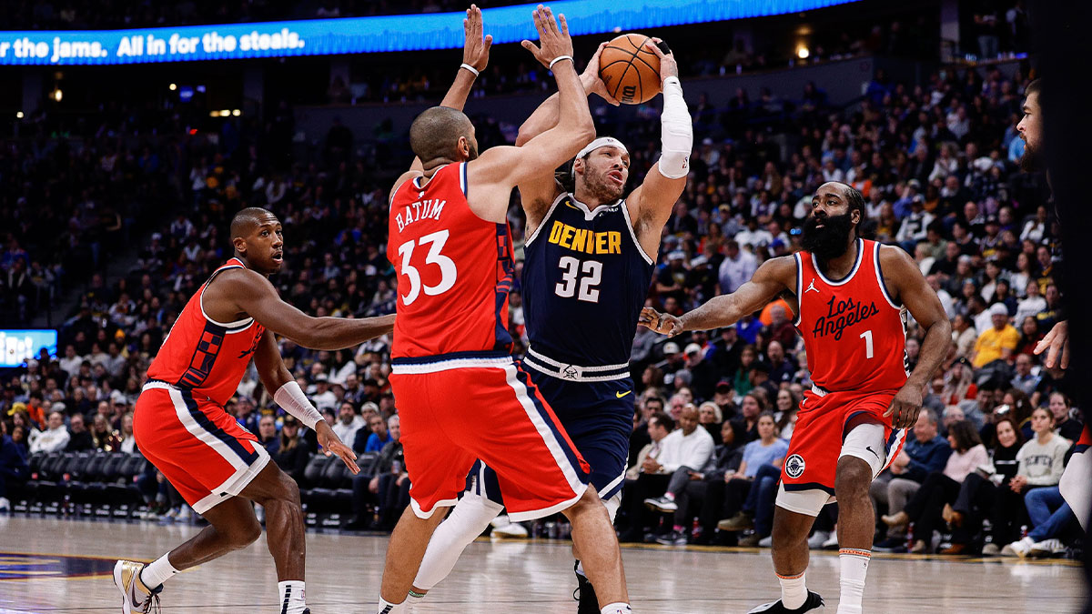 Denver Nuggets forward Aaron Gordon (32) controls the ball against Los Angeles Clippers forward Nicolas Batum (33) as guard Kris Dunn (8) and guard James Harden (1) defend in the third quarter at Ball Arena.