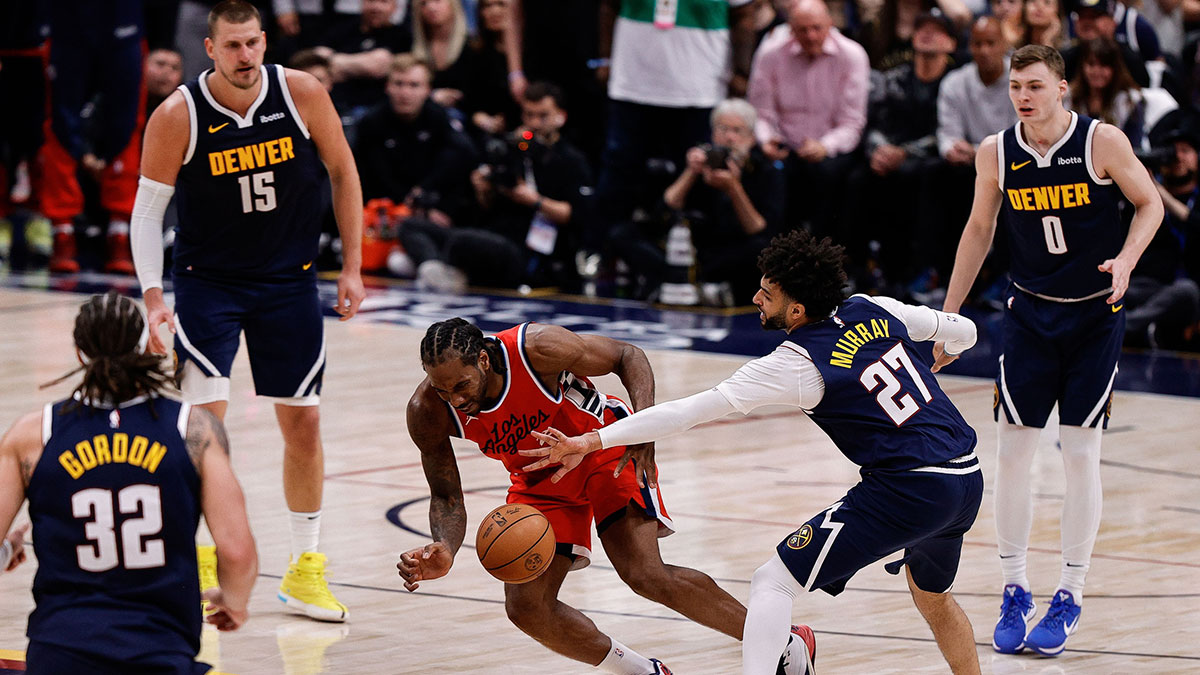 Los Angeles Clippers forward Kawhi Leonard (2) and Denver Nuggets guard Jamal Murray (27) battle for a loose ball in the fourth quarter during game two of first round for the 2025 NBA Playoffs at Ball Arena.