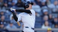 New York Yankees center fielder Cody Bellinger (35) follows through on an RBI sacrifice fly during the seventh inning against the Milwaukee Brewers at Yankee Stadium.