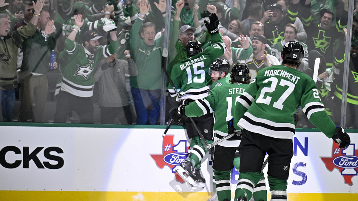 Dallas Stars center Colin Blackwell (15) and center Sam Steel (18) and left wing Mason Marchment (27) celebrate with the Stars fans after Blackwell scores the game winning goal against the Colorado Avalanche during the overtime period in game two of the first round of the 2025 Stanley Cup Playoffs at American Airlines Center.