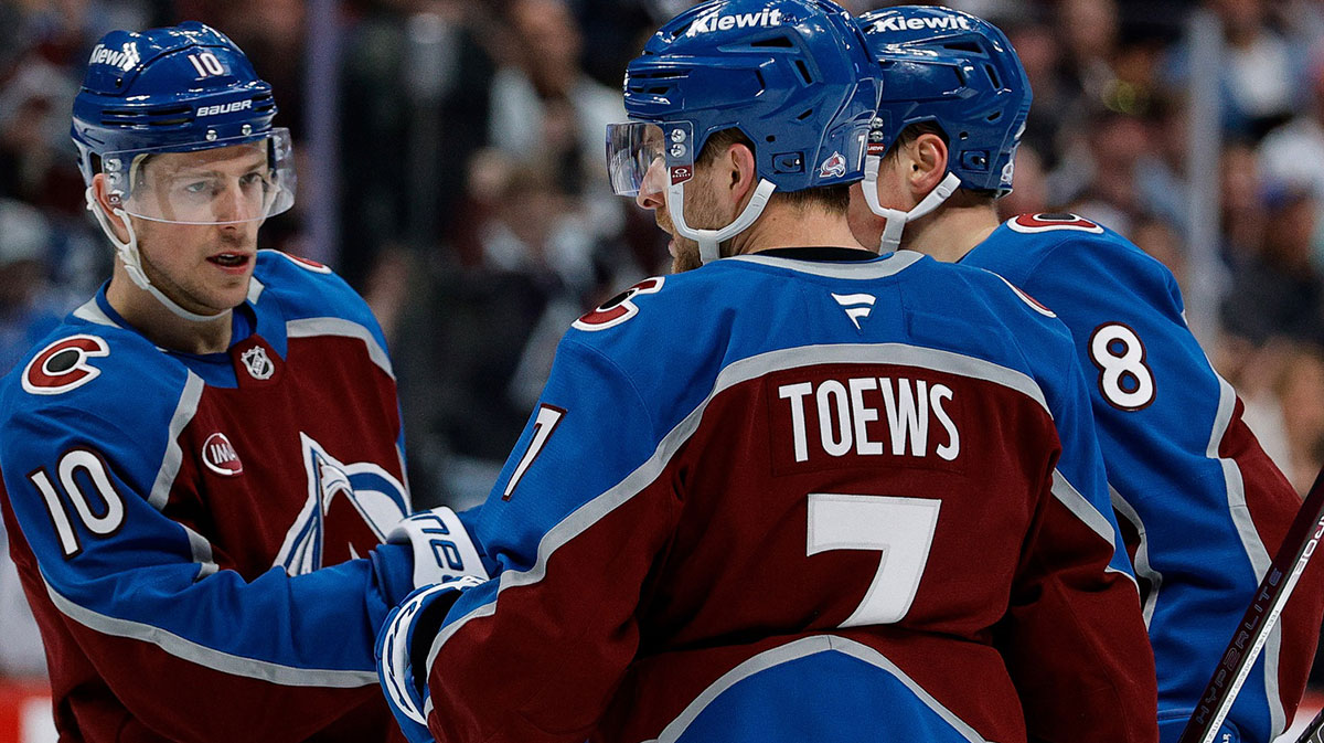 Colorado Avalanche defenseman Devon Toews (7) celebrates his goal with center Charlie Coyle (10) and defenseman Cale Makar (8) in the second period against the Vancouver Canucks at Ball Arena.