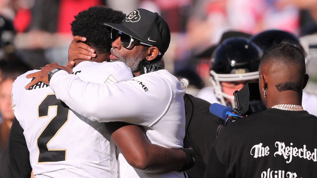 Colorado football coach Deion Sanders hugs his son, Shedeur Sanders, before facing Texas Tech in a Big 12 football game Saturday, Nov. 9, 2024, at Jones AT&T Stadium.