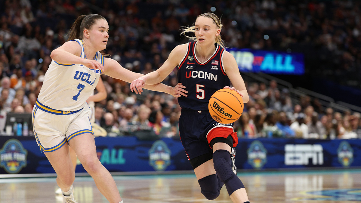 Connecticut Huskies guard Paige Bueckers (5) dribbles against UCLA Bruins guard Elina Aarnisalo (7) during the third quarter in a semifinal of the women's 2025 NCAA tournament at Amalie Arena.