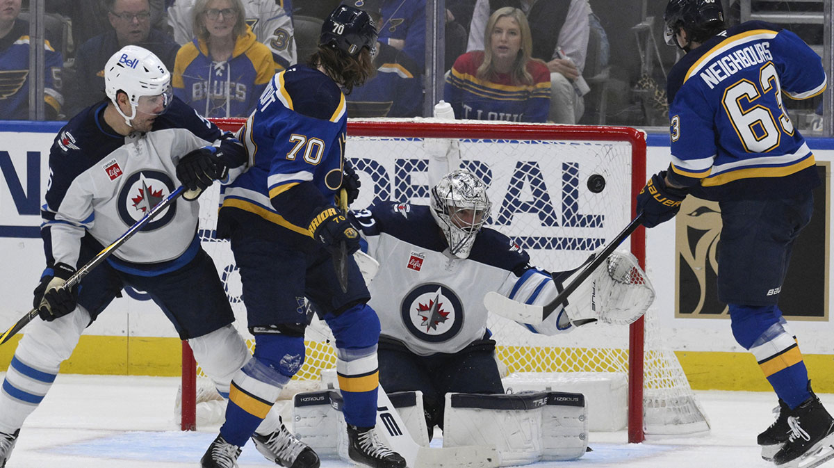Winnipeg Jets goaltender Connor Hellebuyck (37) gives up a goal to St. Louis Blues left wing Jake Neighbours (63) during the first period in game four of the first round of the 2025 Stanley Cup Playoffs at Enterprise Center.