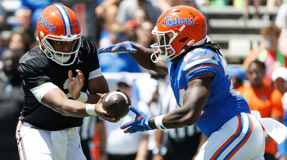 Florida Gators quarterback DJ Lagway (2) hands the ball to Florida Gators running back Ja'Kobi Jackson (24) during the first half at Ben Hill Griffin Stadium.