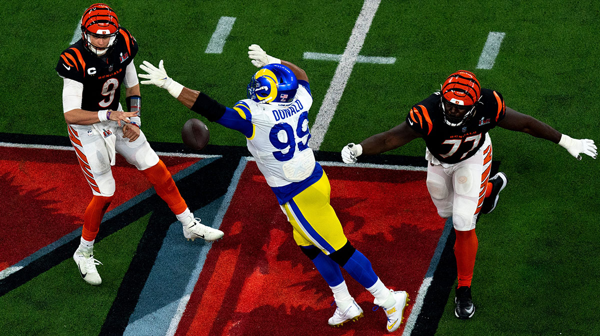 Cincinnati Bengals quarterback Joe Burrow (9) throws the ball as Los Angeles Rams defensive end Aaron Donald (99) pressers him after getting away from Cincinnati Bengals guard Hakeem Adeniji (77) in the second half during Super Bowl 56, Sunday, Feb. 13, 2022, at SoFi Stadium in Inglewood, Calif. Los Angeles Rams defeated Cincinnati Bengals 23-20.