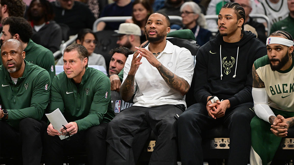 Milwaukee Bucks guard Damian Lillard (center) looks on from the bench while sidelined with an injury in the third quarter against the Phoenix Suns at Fiserv Forum.