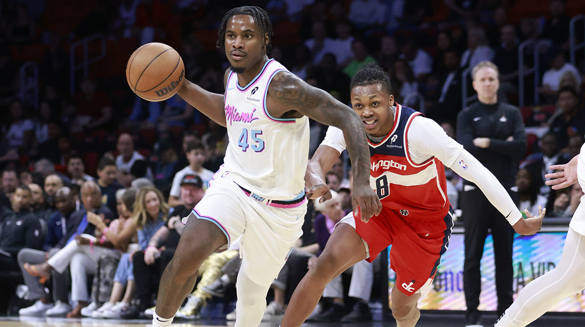 Miami Heat guard Davion Mitchell (45) passes in front of Washington Wizards guard Bub Carrington (8) during the first half at Kaseya Center.