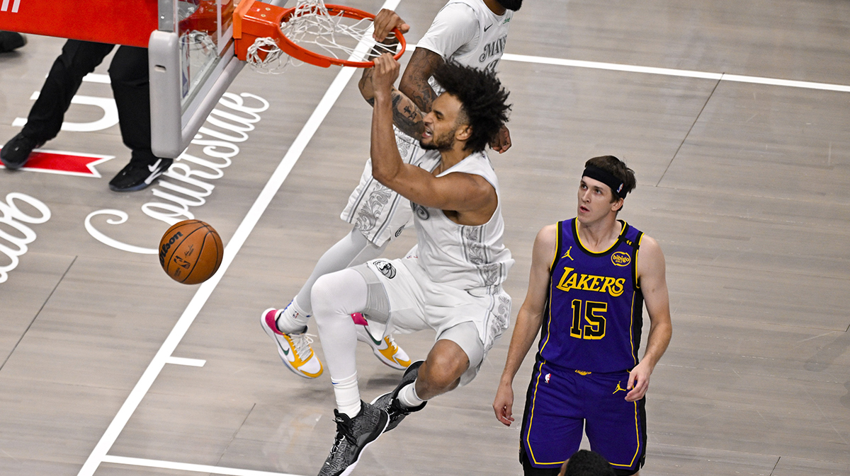 Dallas Mavericks center Dereck Lively II (2) dunks the ball past Los Angeles Lakers guard Austin Reaves (15) during the first quarter at the American Airlines Center.