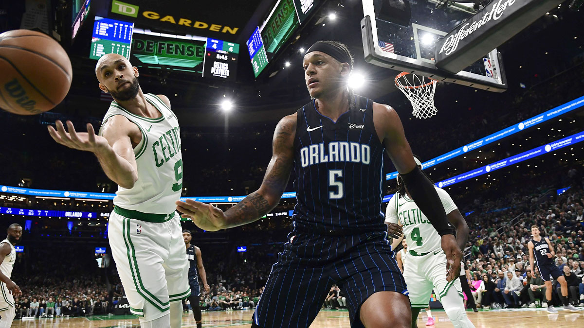 Boston Celtics guard Derrick White (9) tries to save the ball from going out of bounds after Orlando Magic forward Paolo Banchero (5) loses control during the first half at TD Garden.