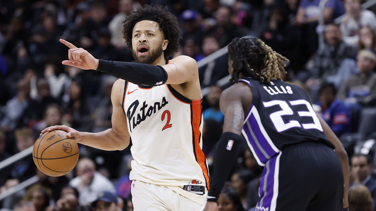 Detroit Pistons guard Cade Cunningham (2) dribbles defended by Sacramento Kings guard Keon Ellis (23) in the second half at Little Caesars Arena.