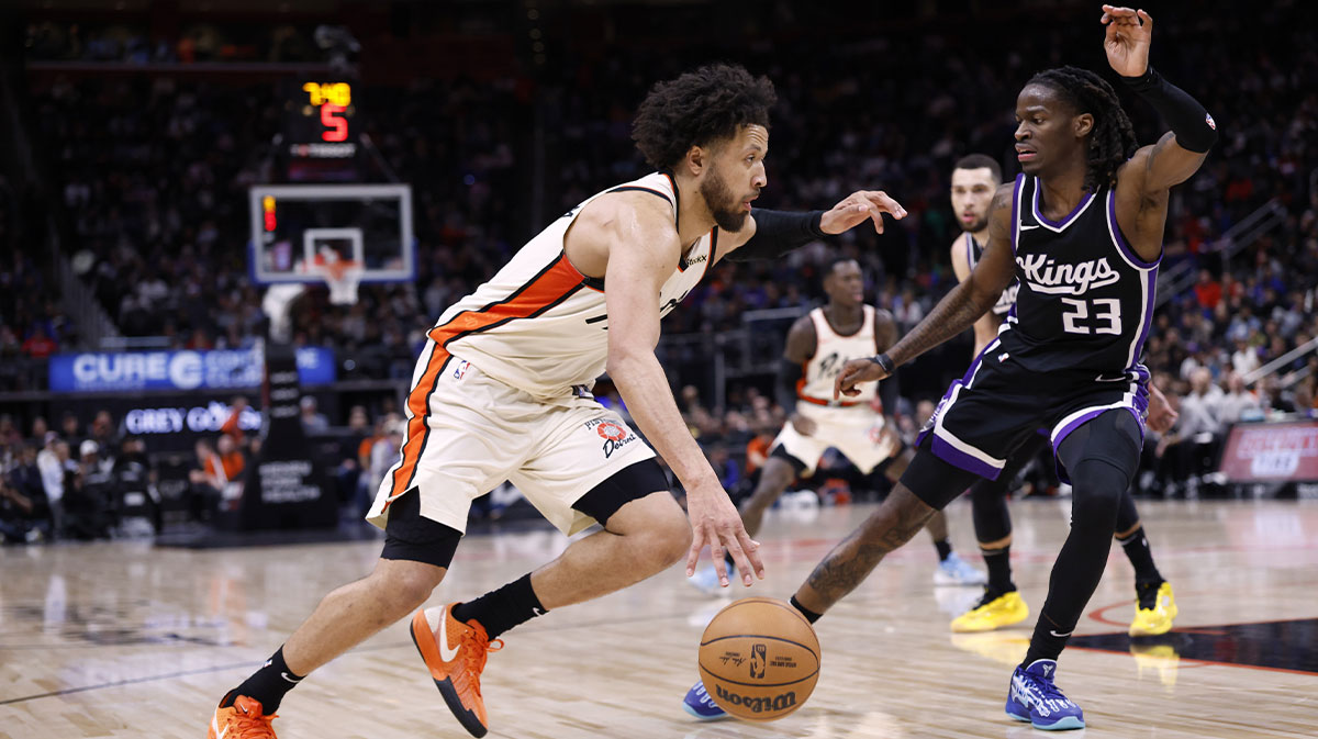 Detroit Pistons guard Cade Cunningham (2) dribbles defended by Sacramento Kings guard Keon Ellis (23) in the second half at Little Caesars Arena.
