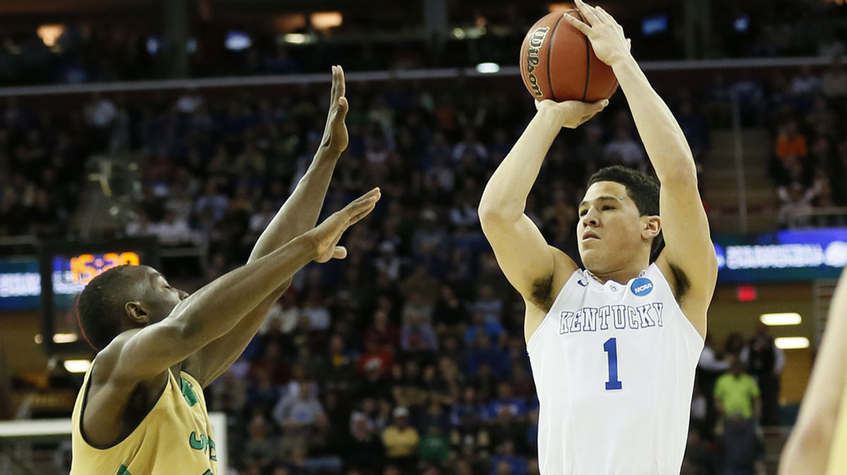 Kentucky Wildcats guard Devin Booker (1) shoots over Notre Dame Fighting Irish guard Jerian Grant (22) during the first half in the finals of the midwest regional of the 2015 NCAA Tournament at Quicken Loans Arena.