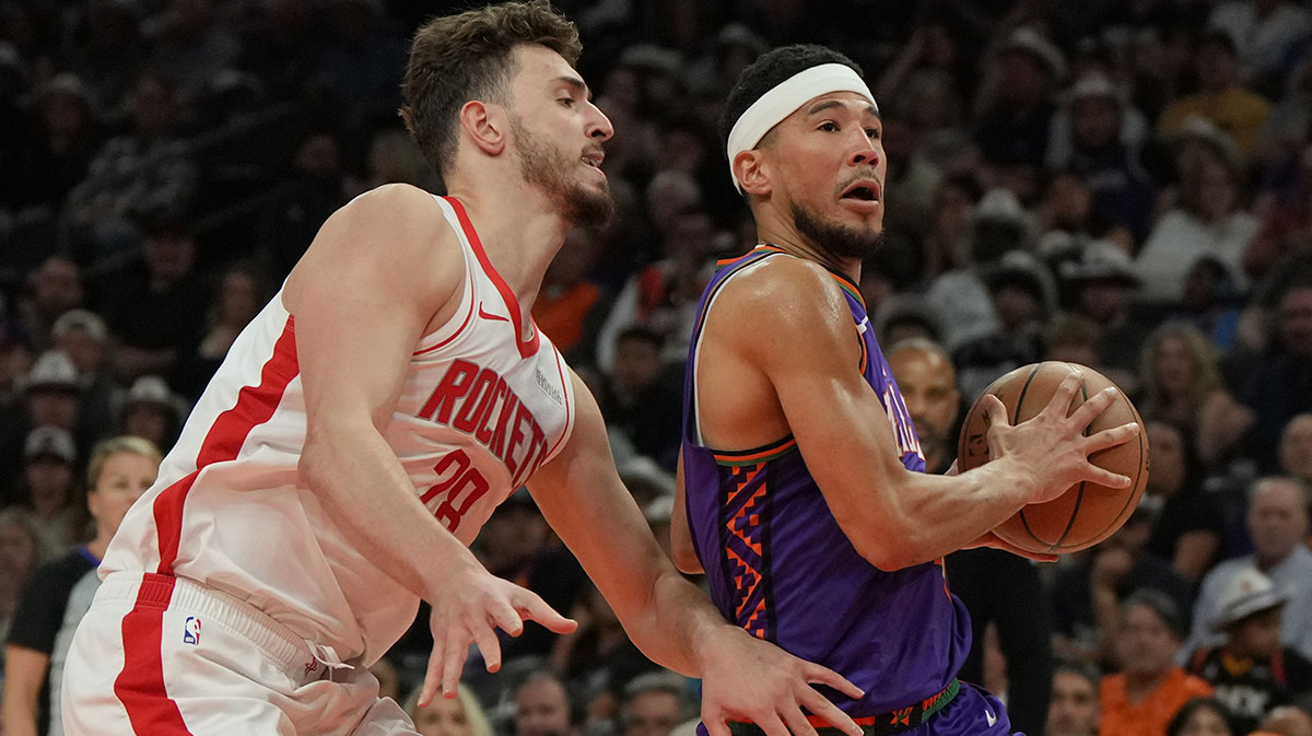 Phoenix Suns guard Devin Booker (1) drives past Houston Rockets center Alperen Sengun (28) in the first half at Footprint Center.