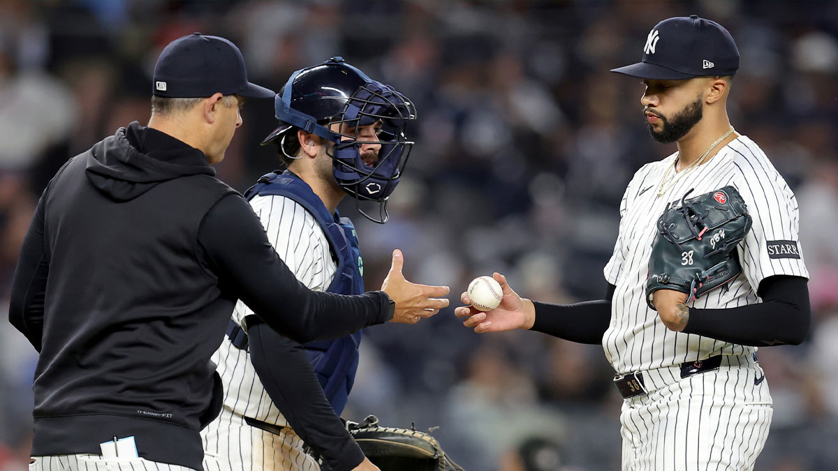 Apr 25, 2025; Bronx, New York, USA; New York Yankees manager Aaron Boone (17) takes the ball from relief pitcher Devin Williams (38) during a pitching change during the ninth inning against the Toronto Blue Jays at Yankee Stadium.