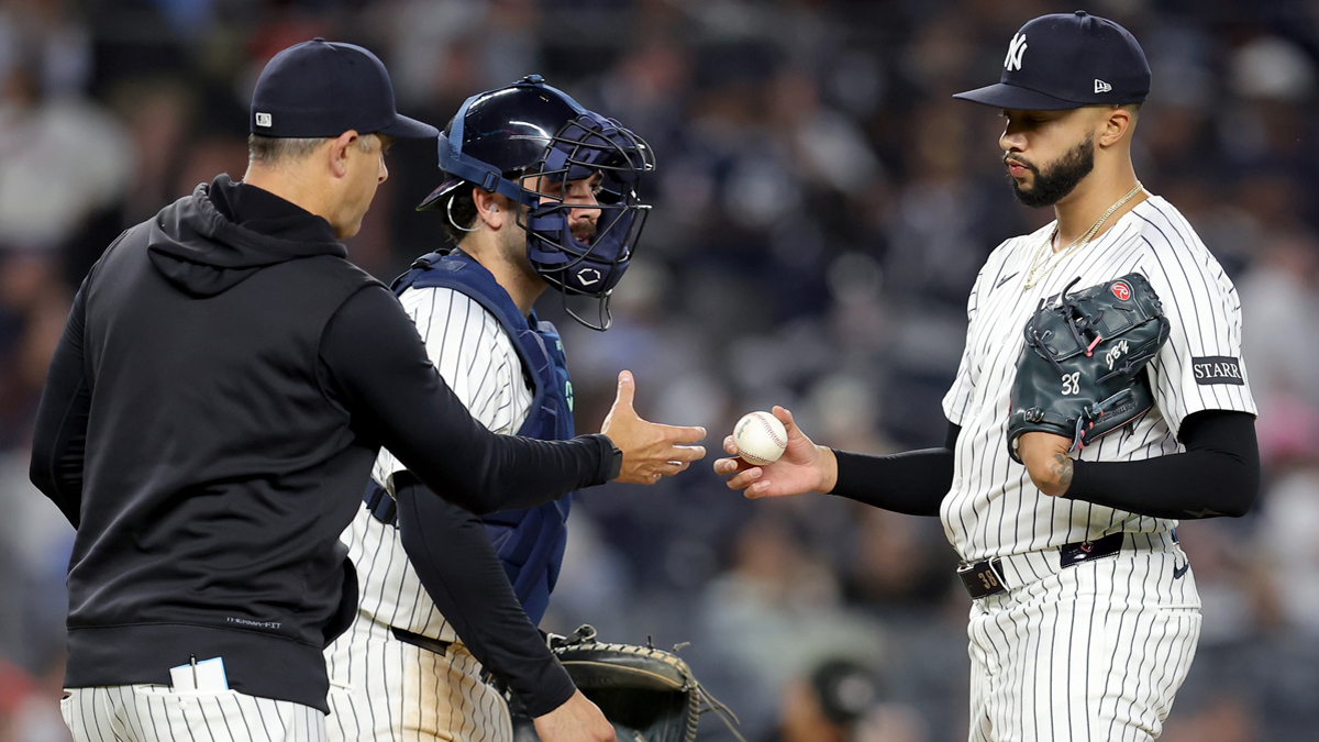 New York Yankees manager Aaron Boone (17) takes the ball from relief pitcher Devin Williams (38) during a pitching change during the ninth inning against the Toronto Blue Jays at Yankee Stadium.