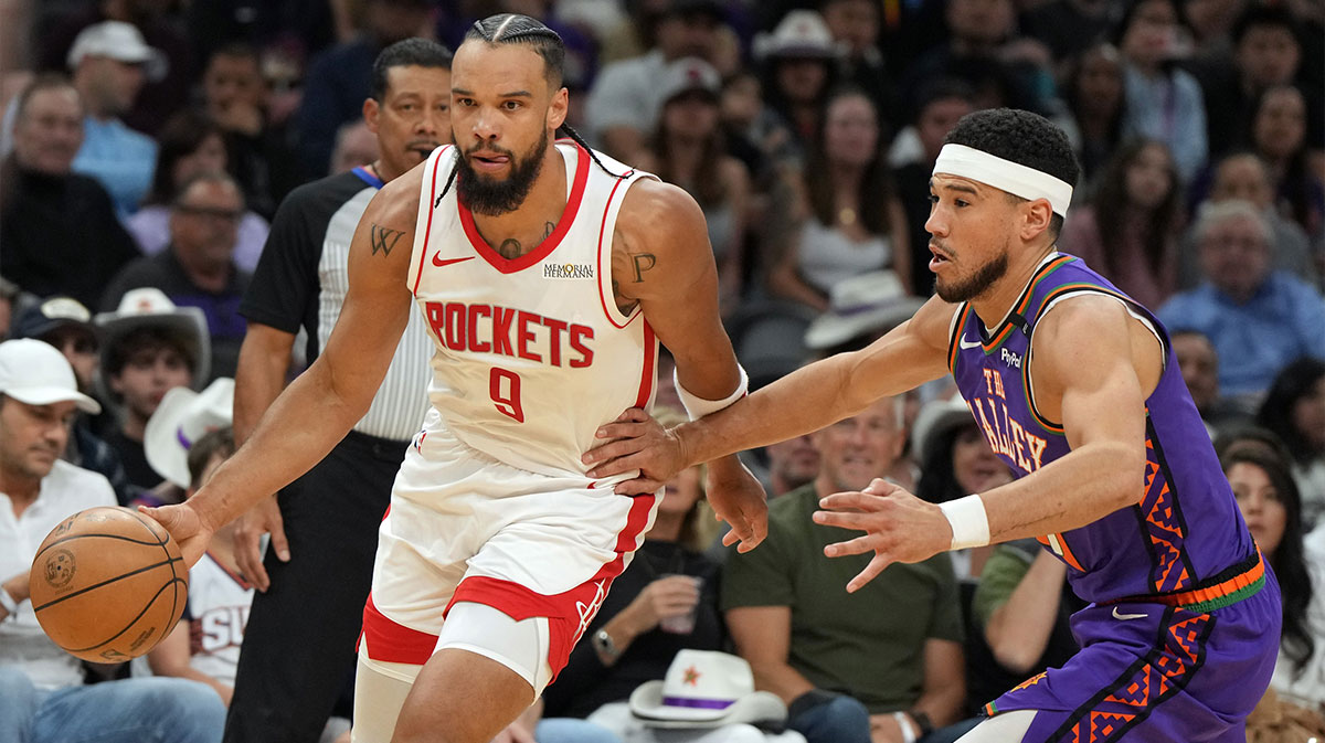 Houston Rockets forward Dillon Brooks (9) drives past Phoenix Suns guard Devin Booker (1) in the first half at Footprint Center.