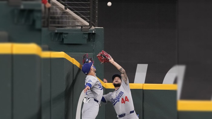 Los Angeles Dodgers center fielder Andy Pages (44) and left fielder Michael Conforto (23) leap for the fly-out hit by Texas Rangers shortstop Corey Seager (not shown) during the first inning at Globe Life Field. Pages made the catch. Mandatory Credit: Jim Cowsert-Imagn Images