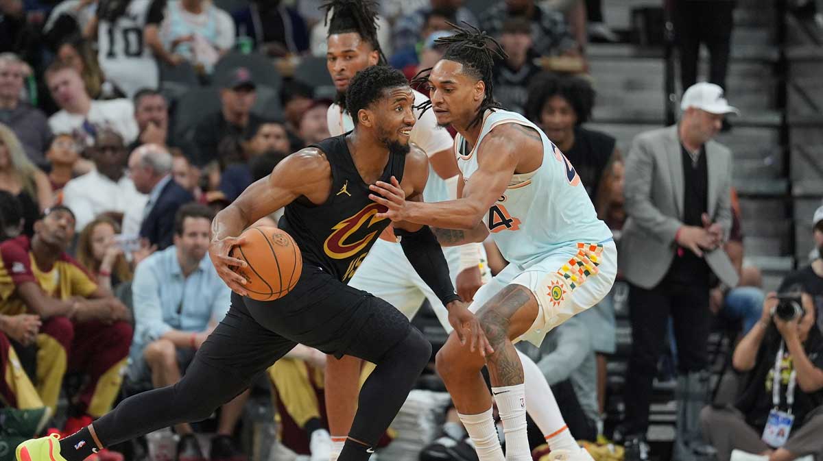 Cleveland Cavaliers guard Donovan Mitchell (45) dribbles against San Antonio Spurs guard Devin Vassell (24) in the second half at Frost Bank Center.