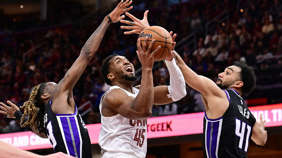 Cleveland Cavaliers guard Donovan Mitchell (45) drives to the basket between Sacramento Kings guard Keon Ellis (23) and forward Trey Lyles (41) during the second half at Rocket Arena.