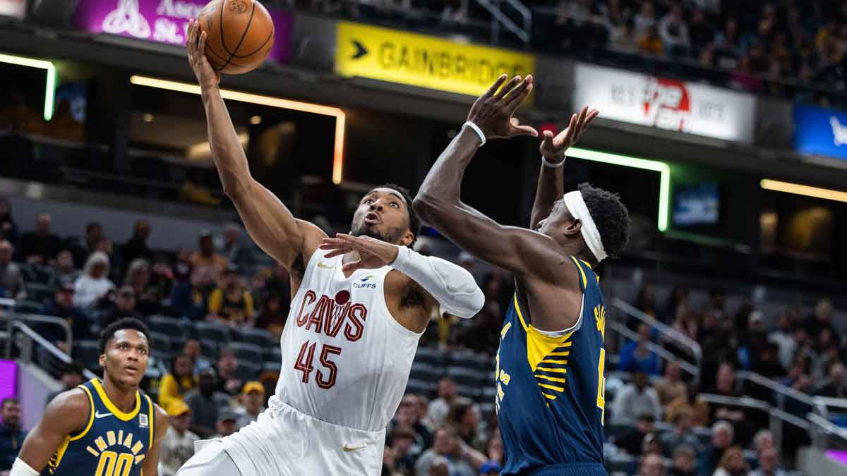 The Cleveland goalkeeper Donovan Mitchell (45) pulls the ball while the Indiana striker Pacers Pascal Siakam (43) defends first half at Gainbridge Fieldhouse.