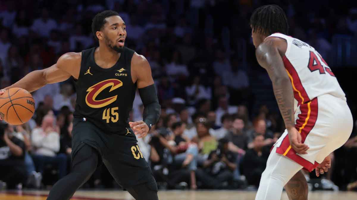 Cleveland Cavaliers guard Donovan Mitchell (45) dribbles the basketball as Miami Heat guard Davion Mitchell (45) defends in the second quarter during game four for the first round of the 2025 NBA Playoffs at Kaseya Center.