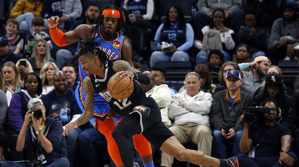 Memphis Grizzlies guard Ja Morant (12) drives to the basket as Oklahoma City Thunder forward Luguentz Dort (5) defends during the second quarter at FedExForum