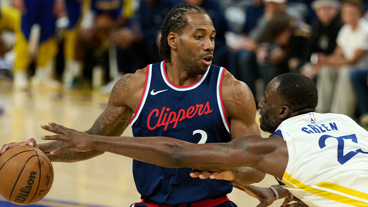 Golden State Warriors forward Draymond Green (23) extends for the ball against LA Clippers forward Kawhi Leonard (2) during the third quarter at Chase Center.