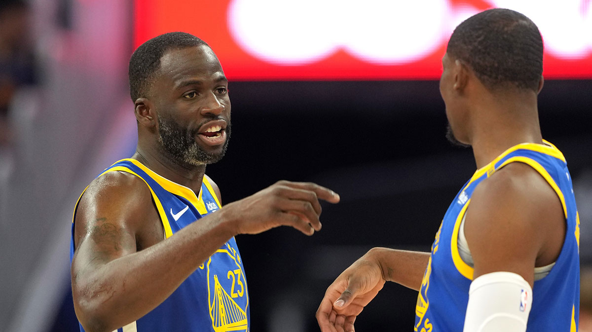 Dec 25, 2024; San Francisco, California, USA; Golden State Warriors forward Draymond Green (23) talks with forward Jonathan Kuminga (right) during the third quarter against the Los Angeles Lakers at Chase Center.